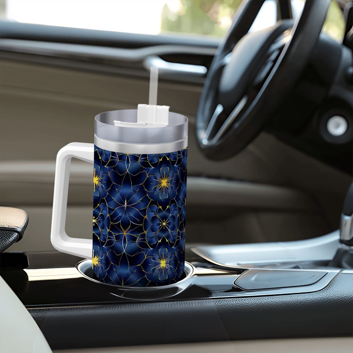 Tumbler with blue floral pattern on a car dashboard