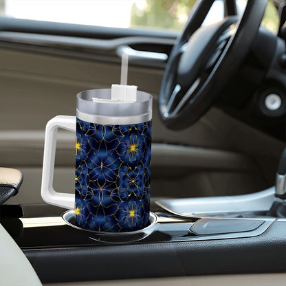 Tumbler with blue floral pattern on a car dashboard