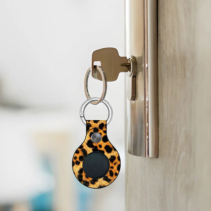 Leopard print keychain attached to a door handle with a blurred background