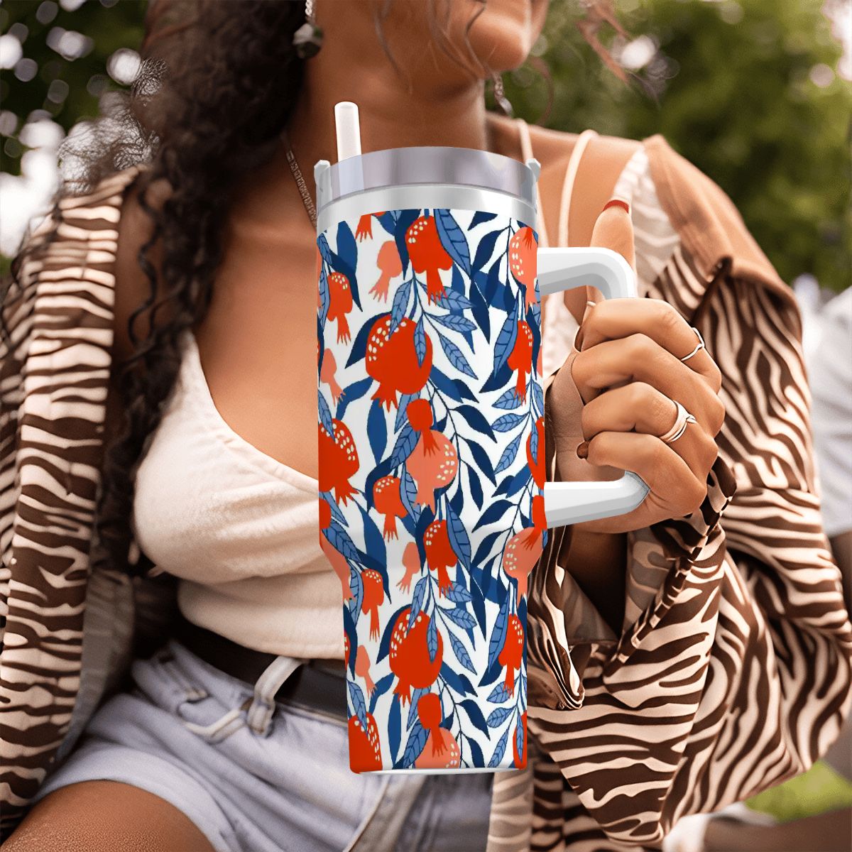 Person holding a colorful water bottle with a floral pattern