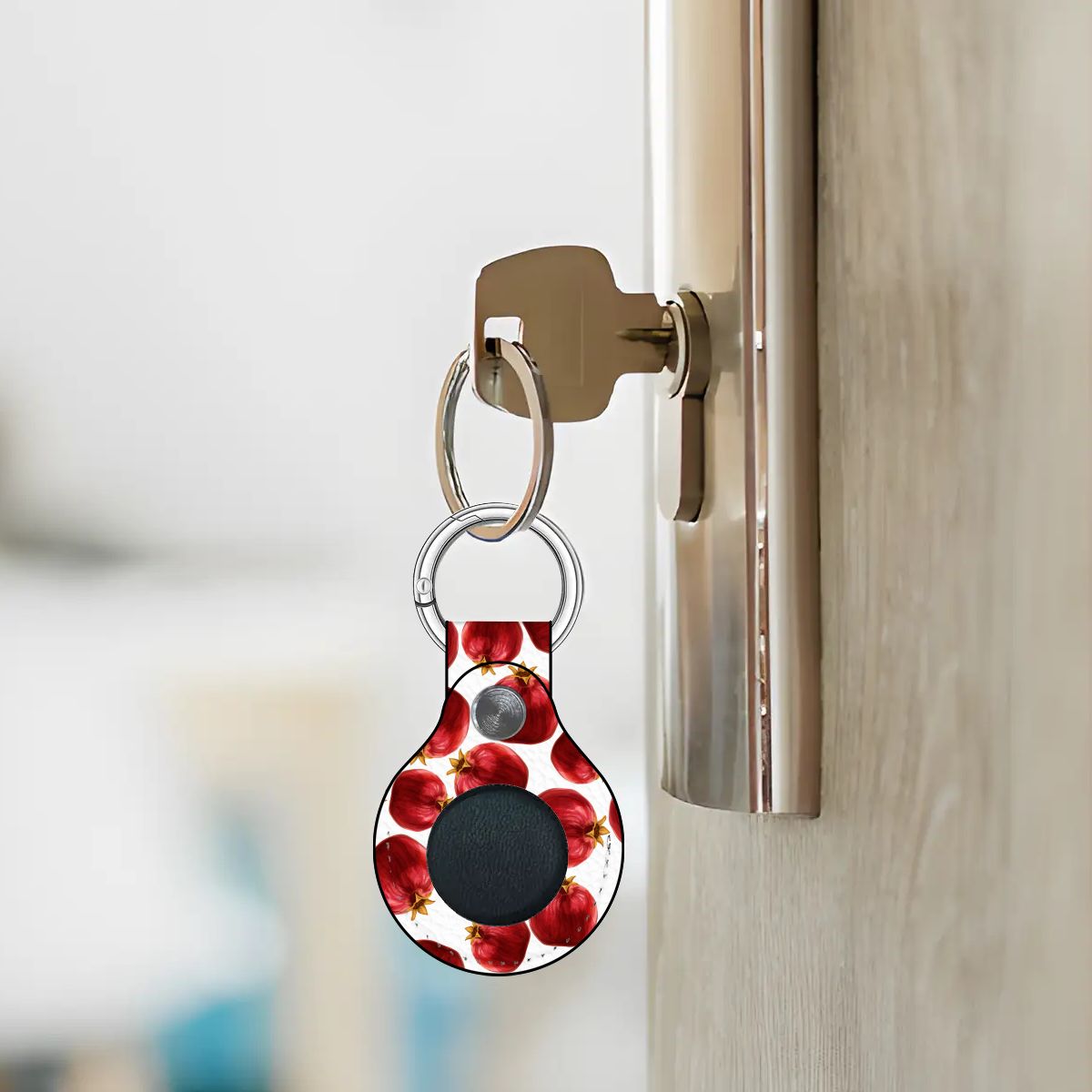Keychain with a floral design attached to a door handle.
