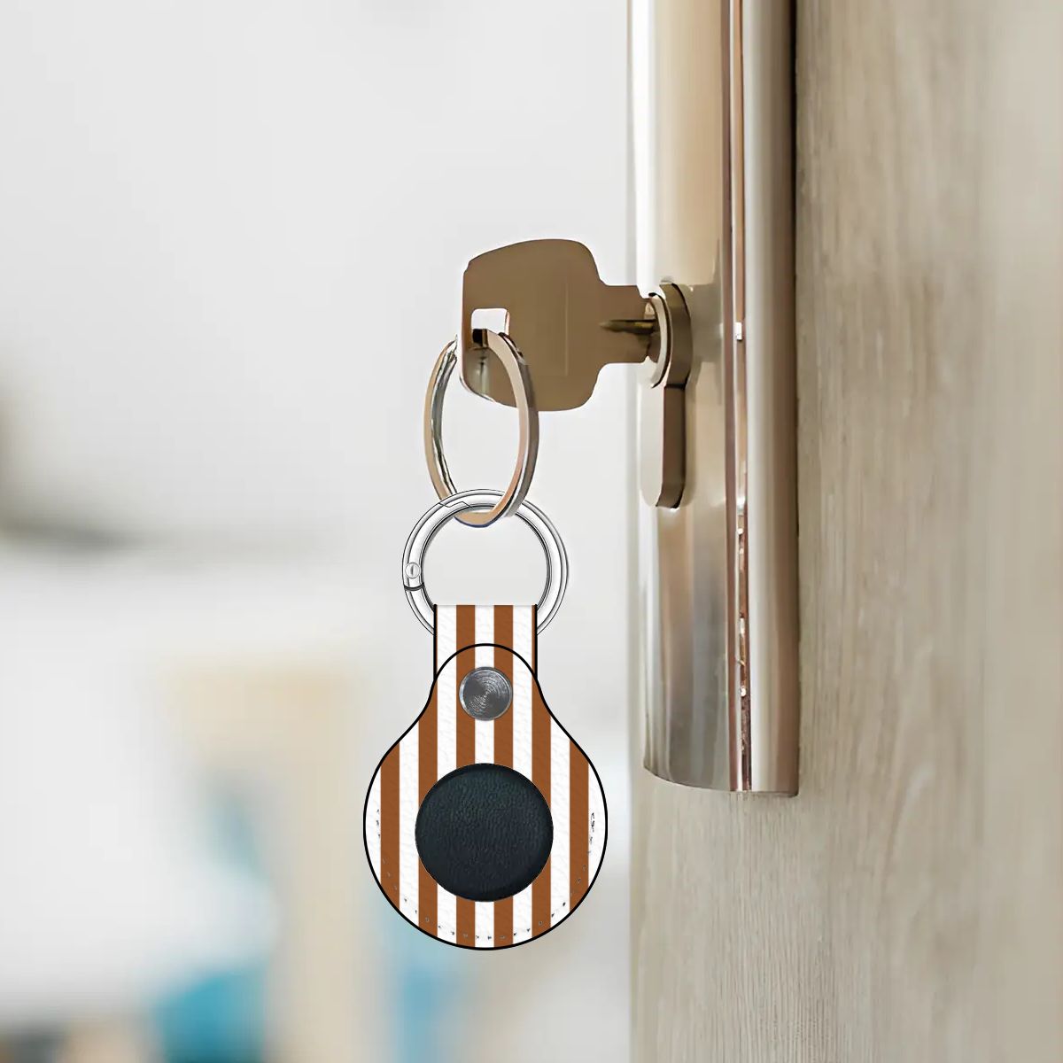 Keychain with a striped design attached to a door handle.